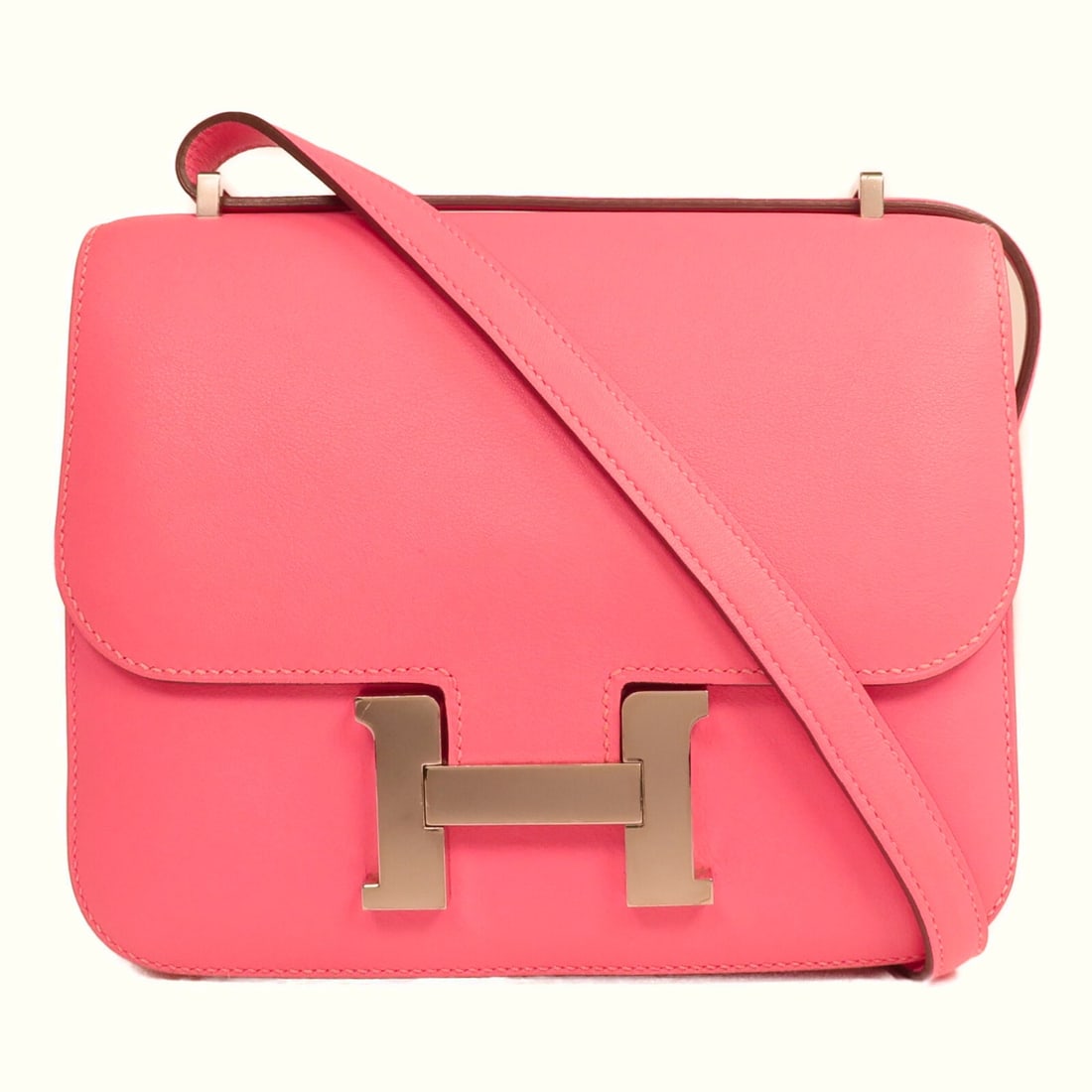 Mini Constance Shoulder Bag in Swift Leather Pink by Hermes: Mini Constance Shoulder Bag in Swift Leather Pink by Hermes This HERMES Mini Constance 2-way shoulder bag is crafted from Swift calfskin leather in a striking Rose Azalee pink shade. Designed for vers