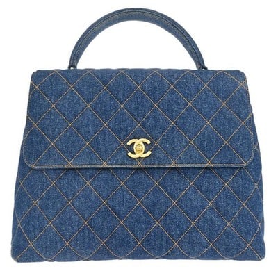 Chanel CC Logos denim top handle bag in blue: Chanel CC Logos denim top handle bag in blue Blue denim canvas top handle handbag with one exterior pocket and two interior pockets, including one zip pocket. Made in France. Includes the serial stick