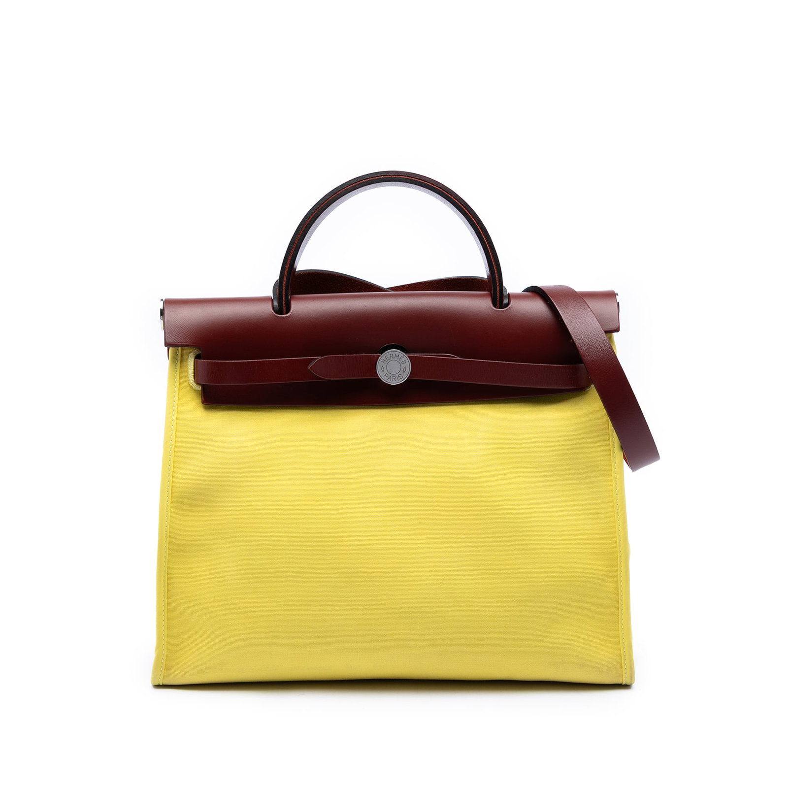 Hermes Herbag Zip 31 Yellow Fabric Bag: Hermes Herbag Zip 31 Yellow Fabric Bag The Hermes Toile Herbag Zip 31 is crafted with a canvas body accented by leather trim. It features a flat leather top handle and a flat leather shoulder strap fo