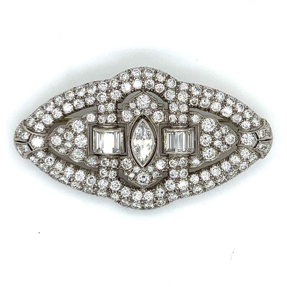 Art Deco Platinum Brooch 7.15 Ct Diamonds Marquise 0.65 Ct: Art Deco Platinum Brooch 7.15 Ct Diamonds Marquise 0.65 Ct This stunning Art Deco brooch is crafted in platinum and features a remarkable total diamond weight of 7.15 ct. It is adorned with a striking