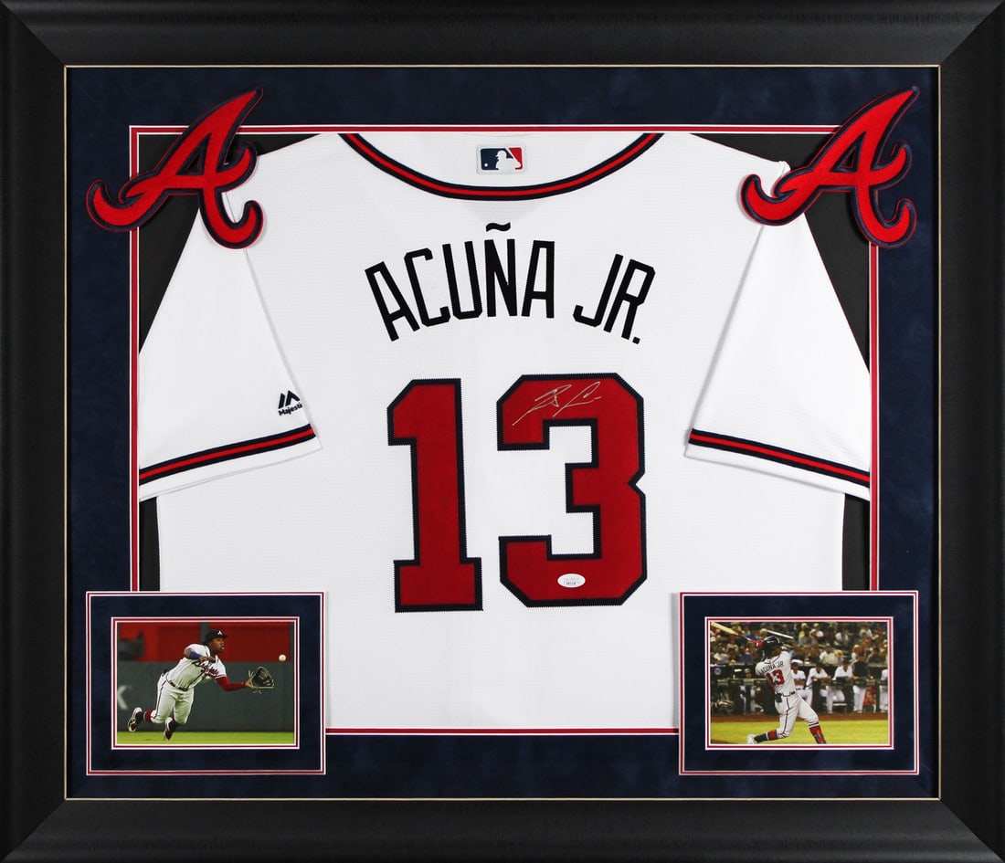 Framed White Jersey Signed by Ronald Acuna Jr JSA Authenticated: Framed White Jersey Signed by Ronald Acuna Jr JSA Authenticated This professionally framed white jersey features the authentic signature of Ronald Acuna Jr. from the Atlanta Braves. The jersey is a cu