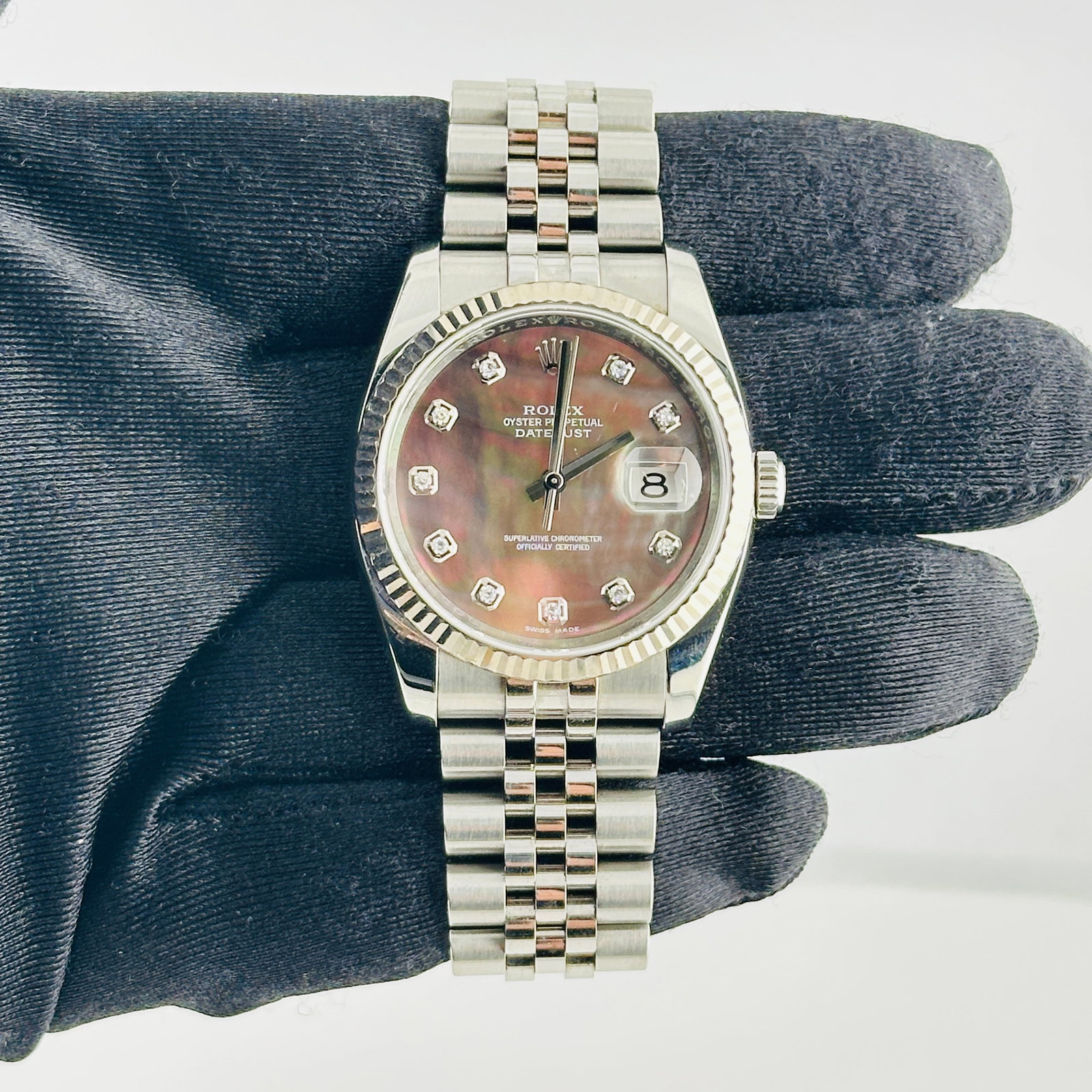 Rolex 116234 Datejust mens watch black mother of pearl diamond dial: Rolex 116234 Datejust mens watch black mother of pearl diamond dial This Rolex Datejust features a striking black mother of pearl dial adorned with diamond hour markers. The watch is equipped with a f