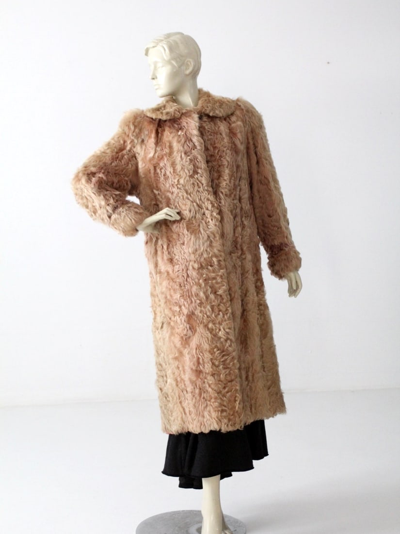 Vintage Rhomberg Curly Lamb Fur Maxi Coat 1940s: Vintage Rhomberg Curly Lamb Fur Maxi Coat 1940s Step back in time with this exquisite Vintage Rhomberg's Curly Lamb Fur Coat from the 1940s. Crafted from soft, light brown curly fur, this maxi coat fe