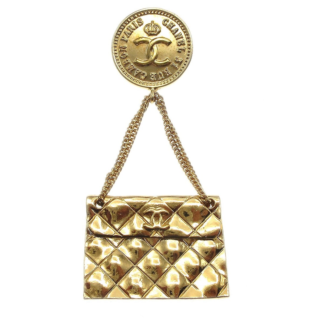 CHANEL handbag motif brooch pin gold plated vintage: CHANEL handbag motif brooch pin gold plated vintage Vintage CHANEL brooch in a handbag motif with a gold-tone finish. Made in France, this brooch features a quilted bag design and shows reasonable wea
