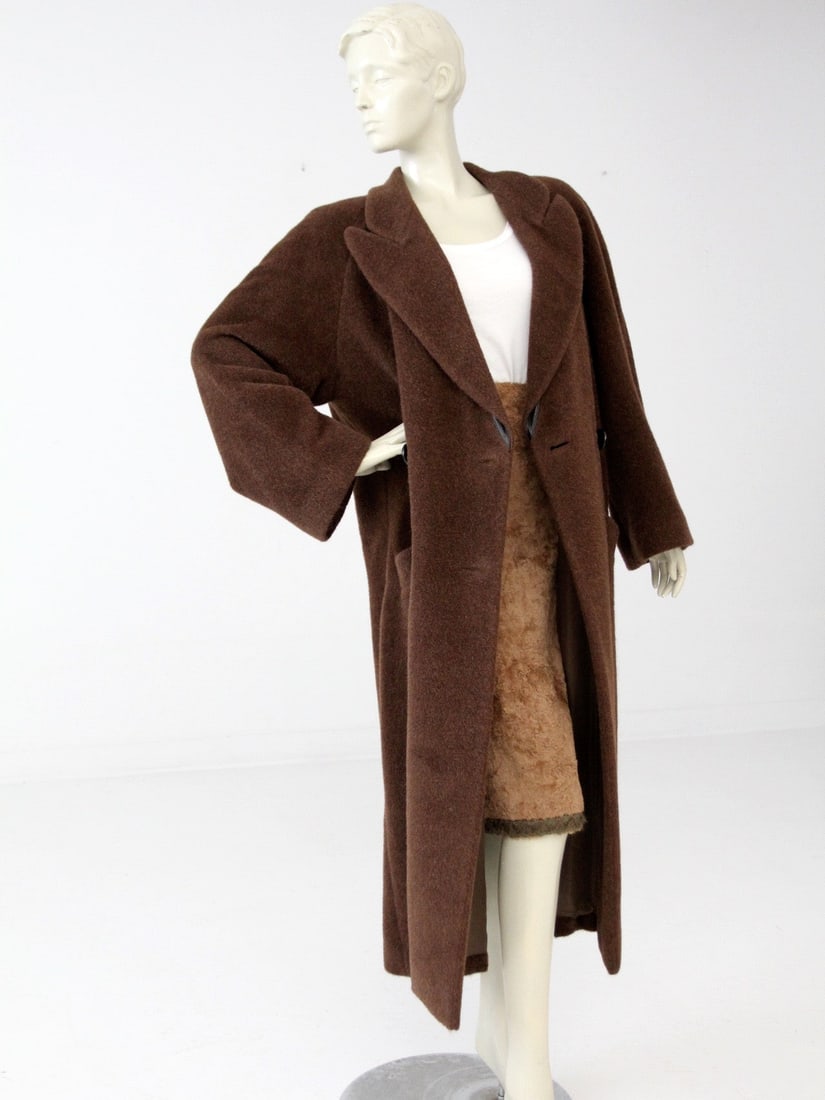 Krizia chocolate brown mohair double breasted topcoat size 42: Krizia chocolate brown mohair double breasted topcoat size 42 This vintage Krizia topcoat from the late 1960s features a double-breasted design in chocolate brown mohair. The coat is accented with a b