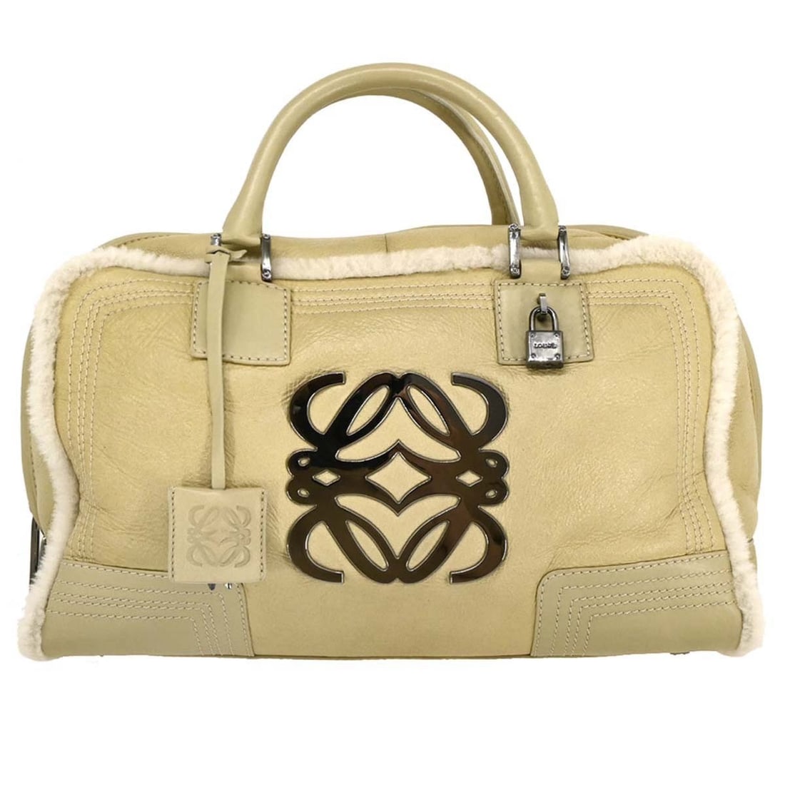 Loewe Amazona 36 Beige Mouton Top Handle Bag: Loewe Amazona 36 Beige Mouton Top Handle Bag Loewe Amazona 36 handbag in beige mouton with double leather handles and zip closure. This large top handle bag features inner pockets and shows good pre-o