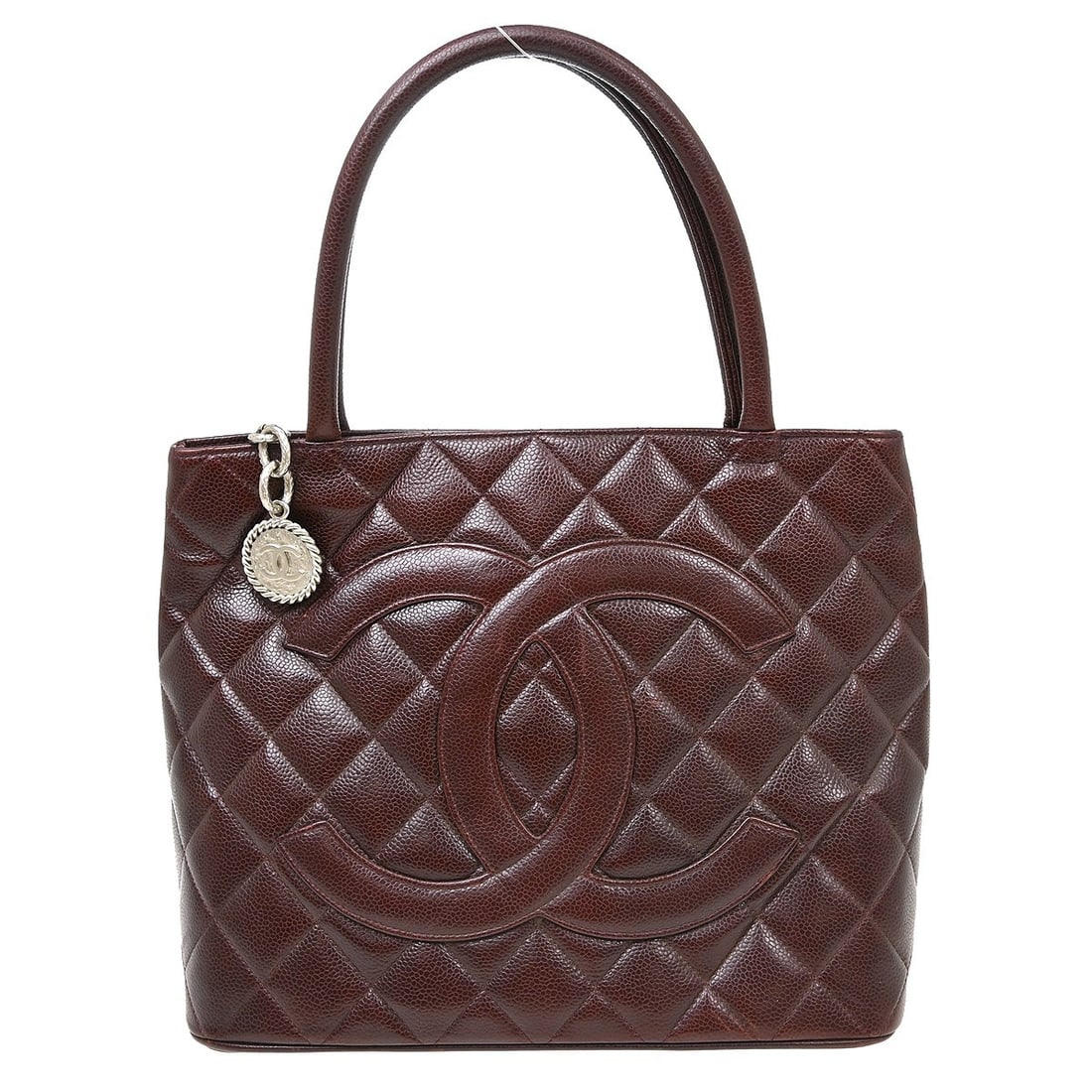 CHANEL Medallion Bordeaux Caviar Leather Tote Bag: CHANEL Medallion Bordeaux Caviar Leather Tote Bag Chanel Medallion tote handbag in bordeaux caviar skin leather with a matelasse quilted design, double handles, and zip-top closure. The bag features a