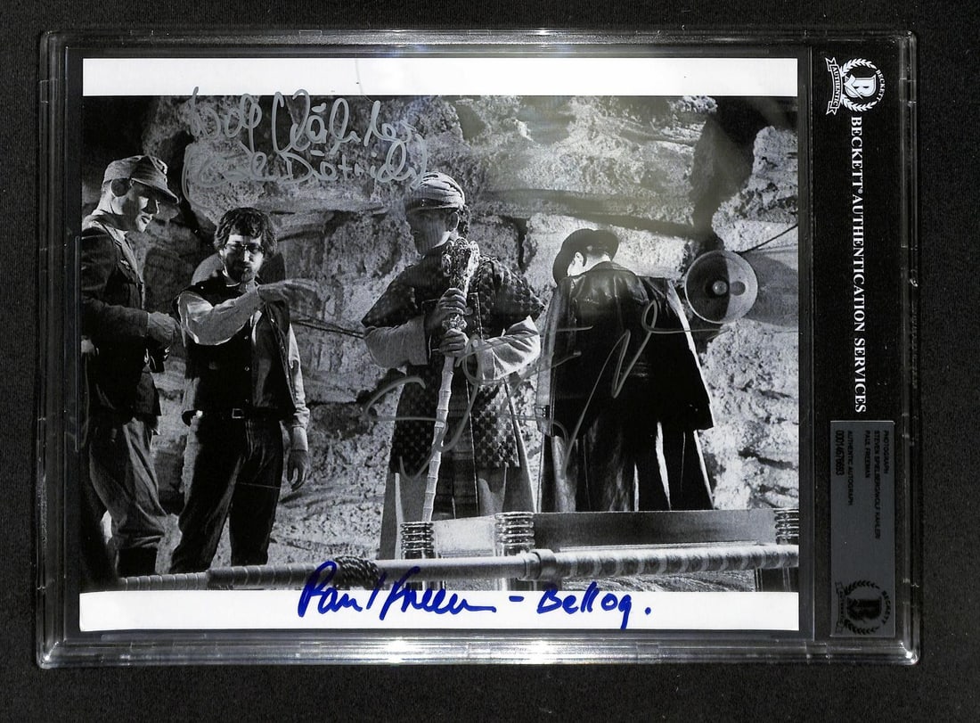 Beckett Certified Indiana Jones 8x10 Photo Signed by Spielberg Kahler Freeman: Beckett Certified Indiana Jones 8x10 Photo Signed by Spielberg Kahler Freeman Signed 8x10 photograph from the Indiana Jones series, hand-signed by Steven Spielberg, Wolf Kahler, and Paul Freeman. The 
