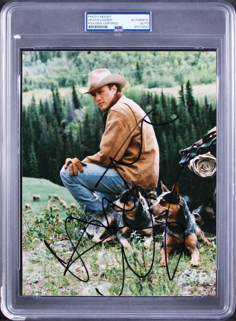Heath Ledger Signed 8x10 Brokeback Mountain Photograph PSA/DNA Authenticated Slab: Heath Ledger Signed 8x10 Brokeback Mountain Photograph PSA/DNA Authenticated Slab This is an authentic 8x10 photograph personally signed by Heath Ledger from the film Brokeback Mountain. The autograph