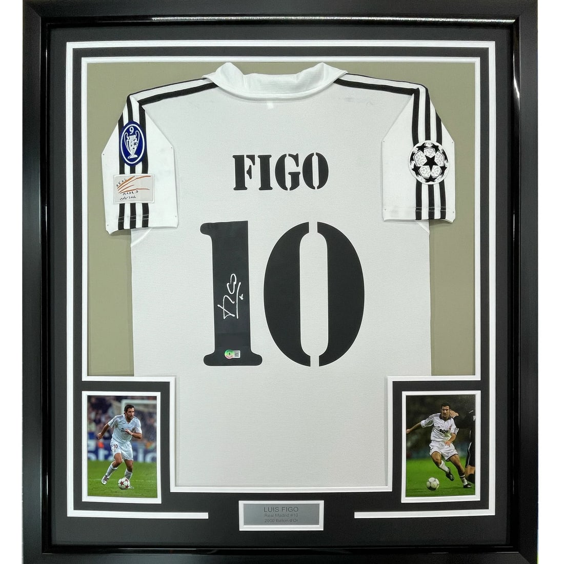 Framed Luis Figo Autographed Real Madrid Jersey BAS Certified: Framed Luis Figo Autographed Real Madrid Jersey BAS Certified Showcase your love for soccer with this stunning framed and autographed Luis Figo Real Madrid jersey. Measuring 35x39 inches, the jersey i