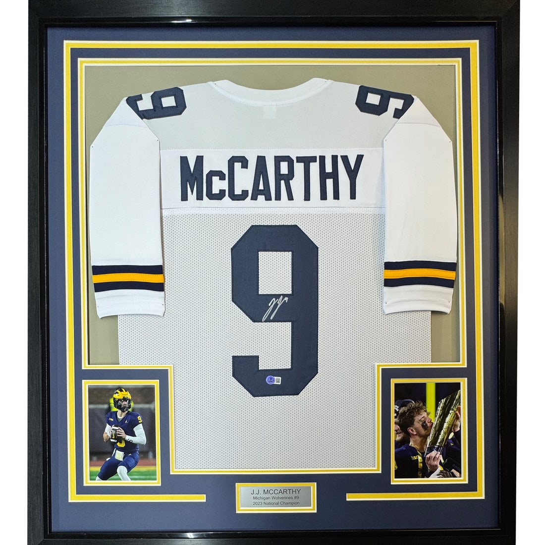 Framed Autographed J.J. McCarthy Michigan Jersey with BAS COA 35x39: Framed Autographed J.J. McCarthy Michigan Jersey with BAS COA 35x39 This professionally framed and matted piece features an autographed J.J. McCarthy Michigan Wolverines white jersey. It comes with a 