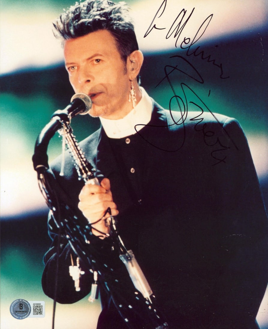 David Bowie Signed 8x10 Photo with Inscription Beckett COA: David Bowie Signed 8x10 Photo with Inscription Beckett COA This authentic 8x10 vertical photograph captures the iconic David Bowie, personally signed with the inscription 'To Melanie.' The signature h
