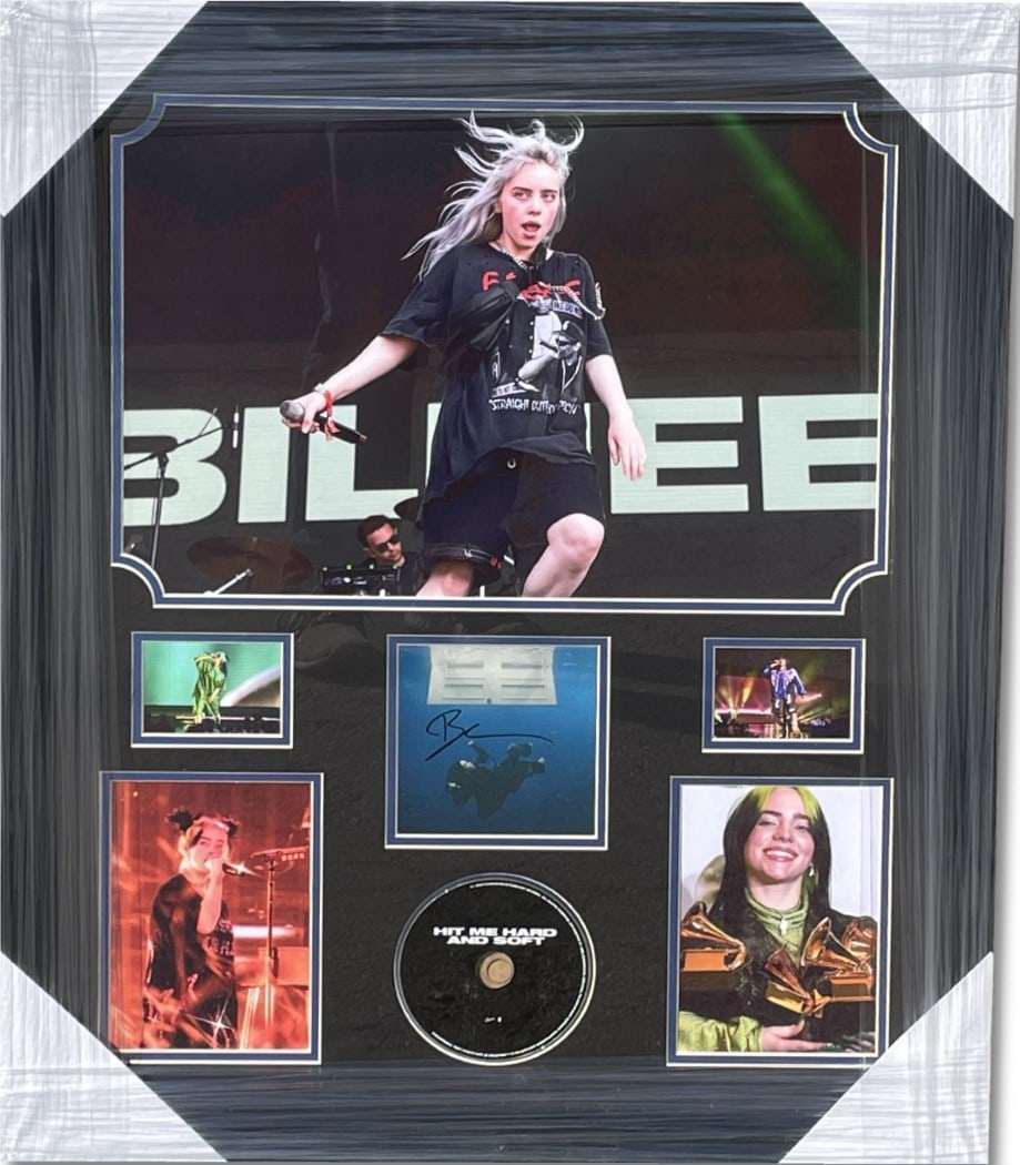 Billie Eilish Autographed CD Cover Framed 24x29 JSA Certified: Billie Eilish Autographed CD Cover Framed 24x29 JSA Certified This framed Billie Eilish autographed CD cover showcases the artist's signature, making it a must-have for fans and collectors. The origin