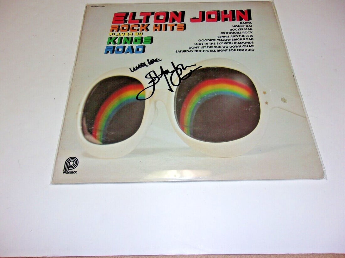 Signed Elton John LP Album With COA Featuring Rock Classics: Signed Elton John LP Album With COA Featuring Rock Classics This is an original LP record album featuring Elton John, signed by the artist. The album includes rock hits from "Yellow Brick Road" and co
