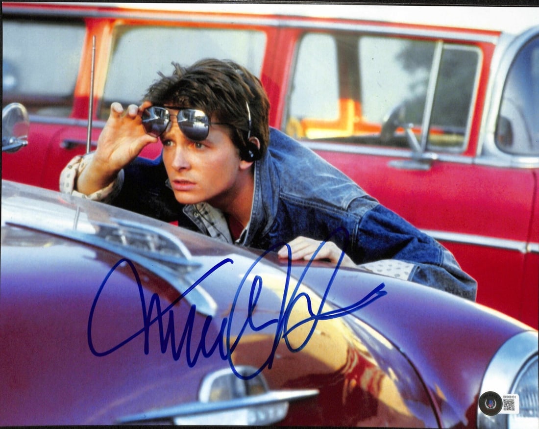 Michael J. Fox Signed Back to the Future II 11x14 Photo Beckett Certified: Michael J. Fox Signed Back to the Future II 11x14 Photo Beckett Certified This impressive 11x14 photograph features a bold signature from actor Michael J. Fox, best known for his role in the iconic fi