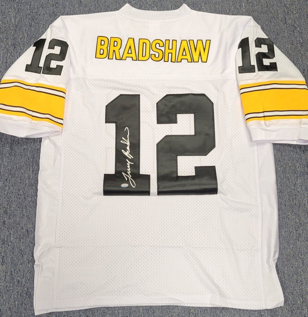 Terry Bradshaw Signed Mitchell & Ness Steelers Jersey Authenticated by Mounted Memories: Terry Bradshaw Signed Mitchell & Ness Steelers Jersey Authenticated by Mounted Memories This is a pre-owned Pittsburgh Steelers jersey signed by legendary player Terry Bradshaw. The jersey is an origi