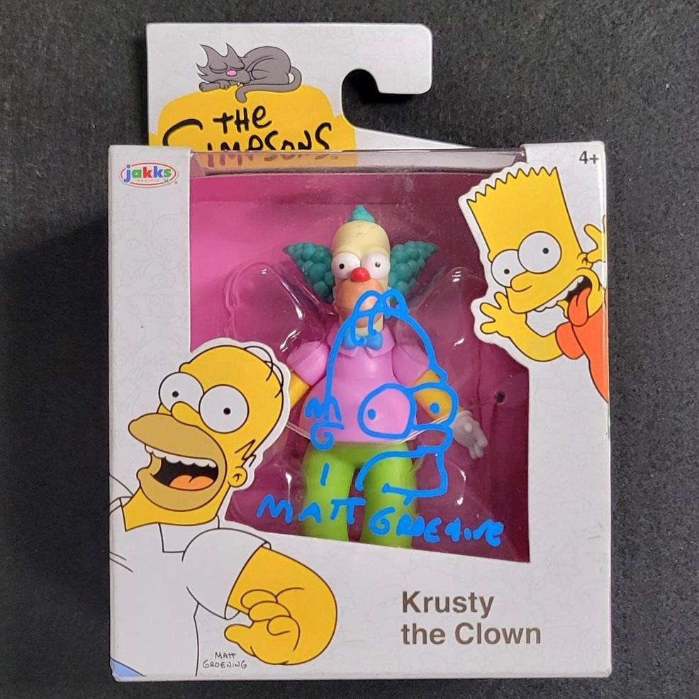 Matt Groening Signed 2.5" Homer Krusty the Clown Figure JSA Authenticated: Matt Groening Signed 2.5" Homer Krusty the Clown Figure JSA Authenticated This collectible mini figure features a 2.5-inch sketch of Homer Simpson, personally signed by the creator of The Simpsons, Ma