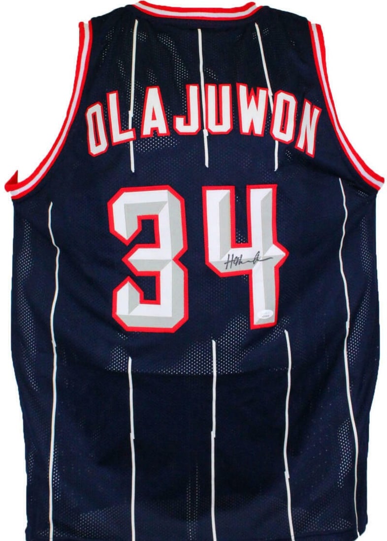 Hakeem Olajuwon signed blue basketball jersey JSA witnessed black: Hakeem Olajuwon signed blue basketball jersey JSA witnessed black This blue basketball jersey is autographed by Hakeem Olajuwon and comes with authentication from James Spence Authentication (JSA). Th