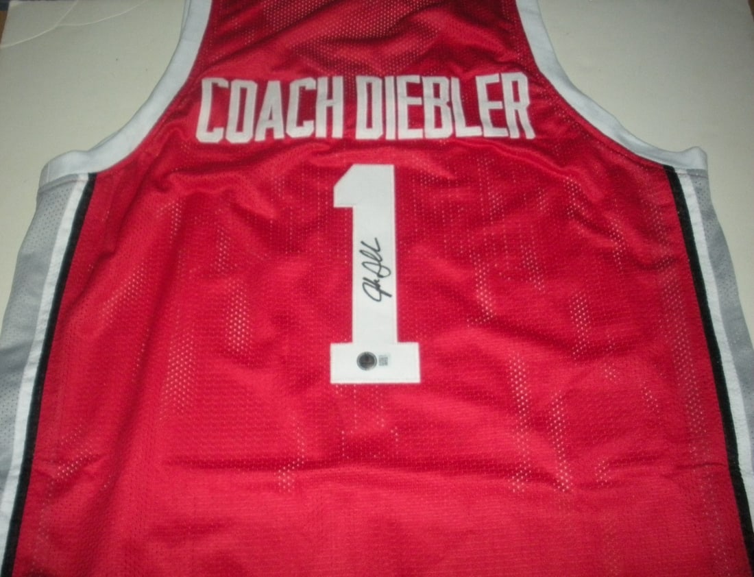 Jake Diebler Signed Red Ohio State Basketball Jersey Beckett COA: Jake Diebler Signed Red Ohio State Basketball Jersey Beckett COA This is a pre-owned Ohio State Buckeyes red basketball jersey signed by Jake Diebler. The jersey is original and includes Beckett Certi