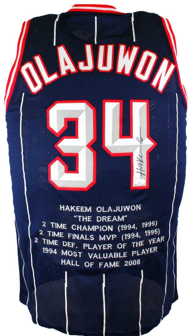Blue Pro Basketball Jersey Signed by Hakeem Olajuwon JSA Authenticated: Blue Pro Basketball Jersey Signed by Hakeem Olajuwon JSA Authenticated This blue Stat Pro jersey is autographed by basketball legend Hakeem Olajuwon and represents the Houston Rockets. The jersey is a