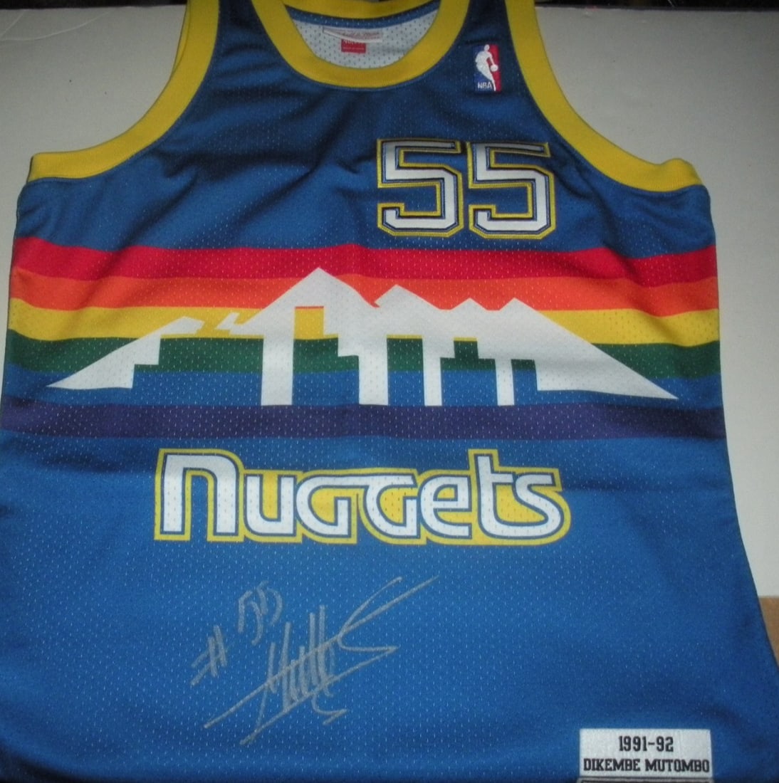 Dikembe Mutombo Signed Mitchell & Ness Official Jersey with PSA COA: Dikembe Mutombo Signed Mitchell & Ness Official Jersey with PSA COA This official licensed Mitchell & Ness jersey features the iconic design associated with basketball legend Dikembe Mutombo. The jers