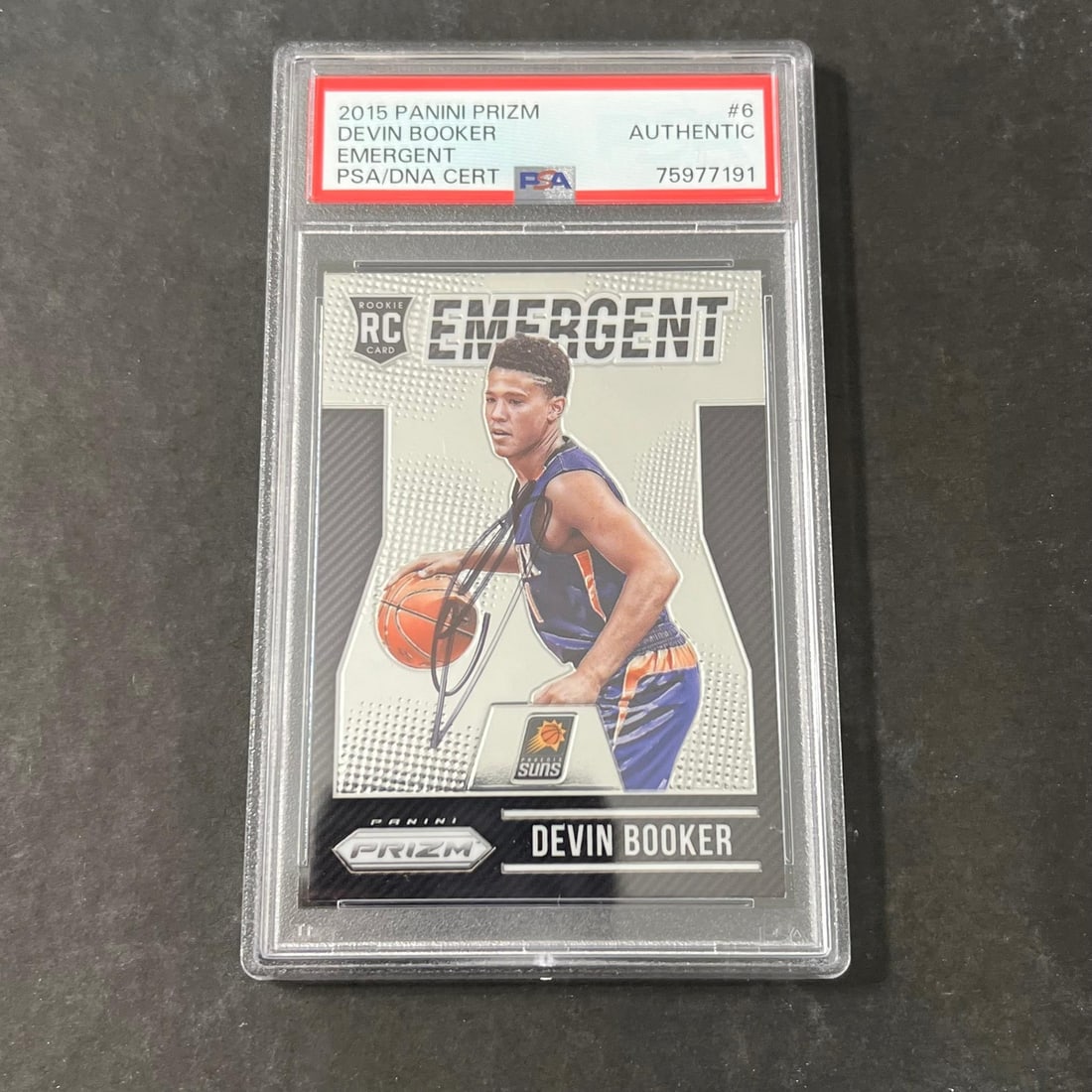 Devin Booker PSA Autographed Rookie Card Panini Prizm 2015-16 #6: Devin Booker PSA Autographed Rookie Card Panini Prizm 2015-16 #6 This is a 2015-16 Panini Prizm #6 rookie card featuring Devin Booker of the Phoenix Suns. The card has been autographed by Devin Booker