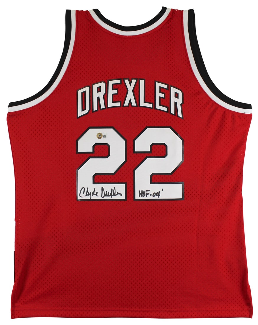 Clyde Drexler Signed Red Mitchell & Ness Jersey HOF 04 BAS Witnessed: Clyde Drexler Signed Red Mitchell & Ness Jersey HOF 04 BAS Witnessed Celebrate the legacy of Clyde Drexler with this autographed red Mitchell & Ness jersey, featuring the inscription "HOF 04." This or