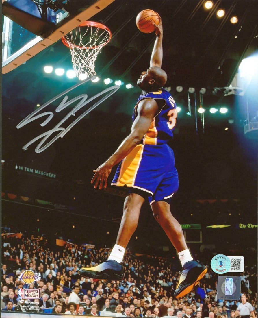 Shaquille O'Neal Signed 8x10 Dunk Photo Purple Jersey BAS Witnessed: Shaquille O'Neal Signed 8x10 Dunk Photo Purple Jersey BAS Witnessed Capture the thrill of the game with this iconic autographed 8x10 photo of Shaquille O'Neal performing a vertical dunk, proudly weari