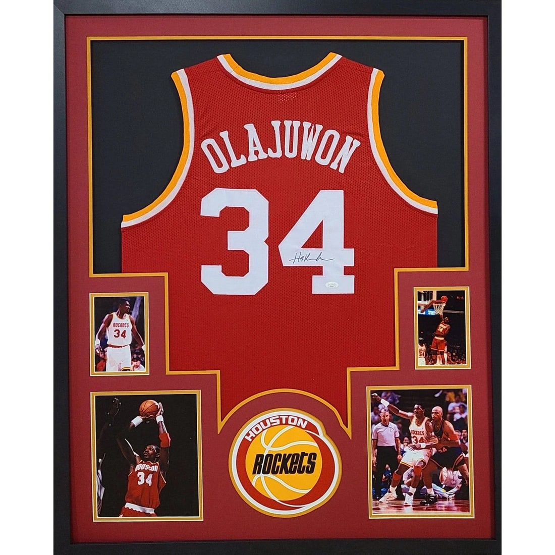 Framed Hakeem Olajuwon Houston Rockets Jersey JSA Autographed: Framed Hakeem Olajuwon Houston Rockets Jersey JSA Autographed This is a framed Houston Rockets jersey autographed by Hakeem Olajuwon. The jersey is authenticated by JSA and includes a tamper-proof sti