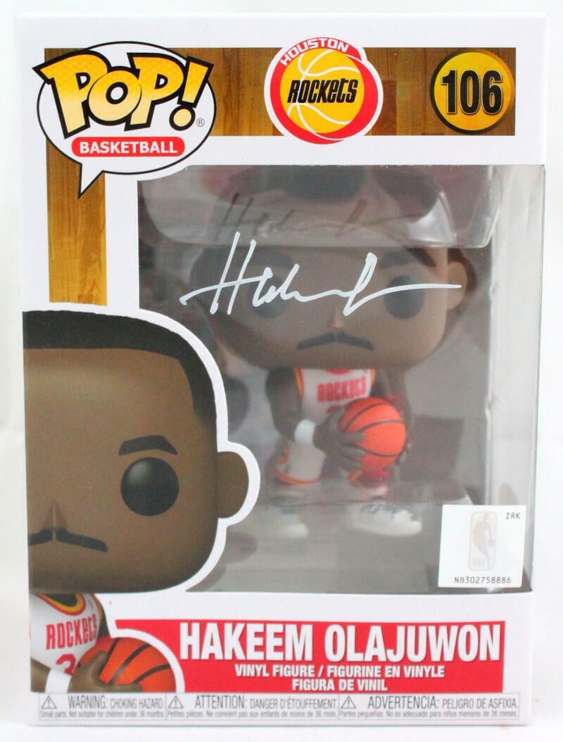 Funko Pop Hakeem Olajuwon Rockets autographed vinyl figure JSA: Funko Pop Hakeem Olajuwon Rockets autographed vinyl figure JSA This pre-owned Funko Pop! vinyl figure features Hakeem Olajuwon of the Houston Rockets and is autographed. The collectible is from the Fu