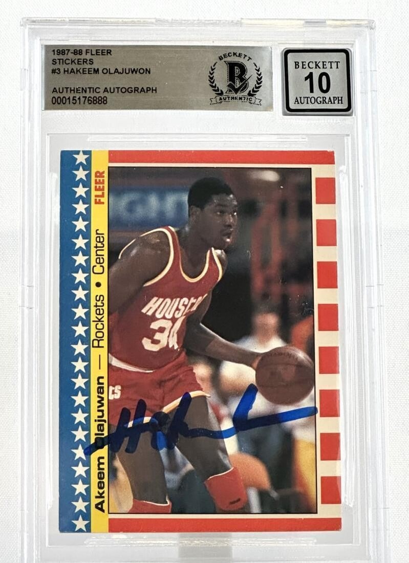 Hakeem Olajuwon 1987-88 Fleer Stickers #3 BAS Autograph: Hakeem Olajuwon 1987-88 Fleer Stickers #3 BAS Autograph This is an original 1987-88 Fleer Stickers #3 basketball card featuring Hakeem Olajuwon of the Houston Rockets. The card is hard signed by Hakee