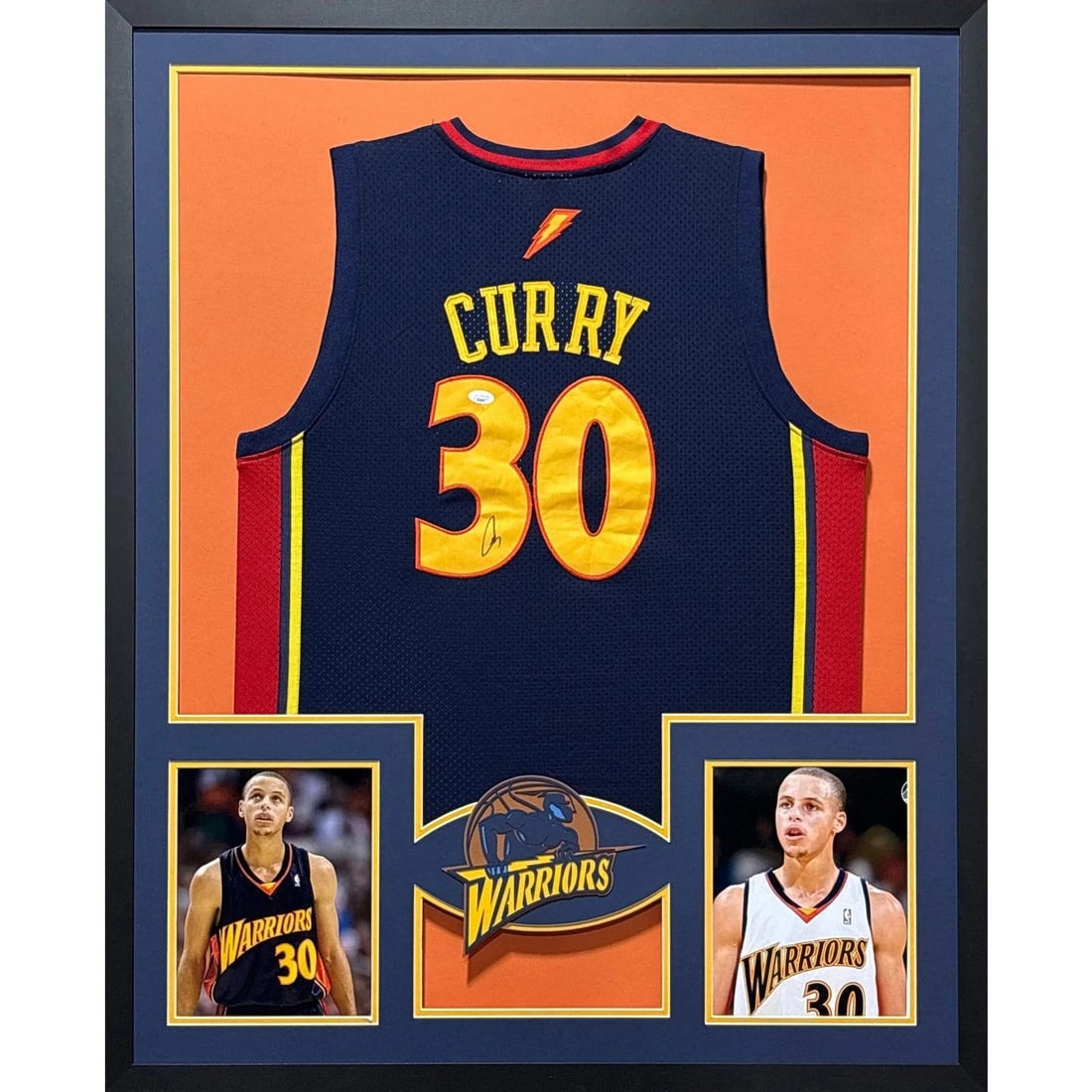 Framed Stephen Curry Autographed Warriors Jersey with JSA Authentication: Framed Stephen Curry Autographed Warriors Jersey with JSA Authentication This is a framed Stephen Curry rookie jersey, autographed by Steph Curry. The jersey includes JSA authentication and features a