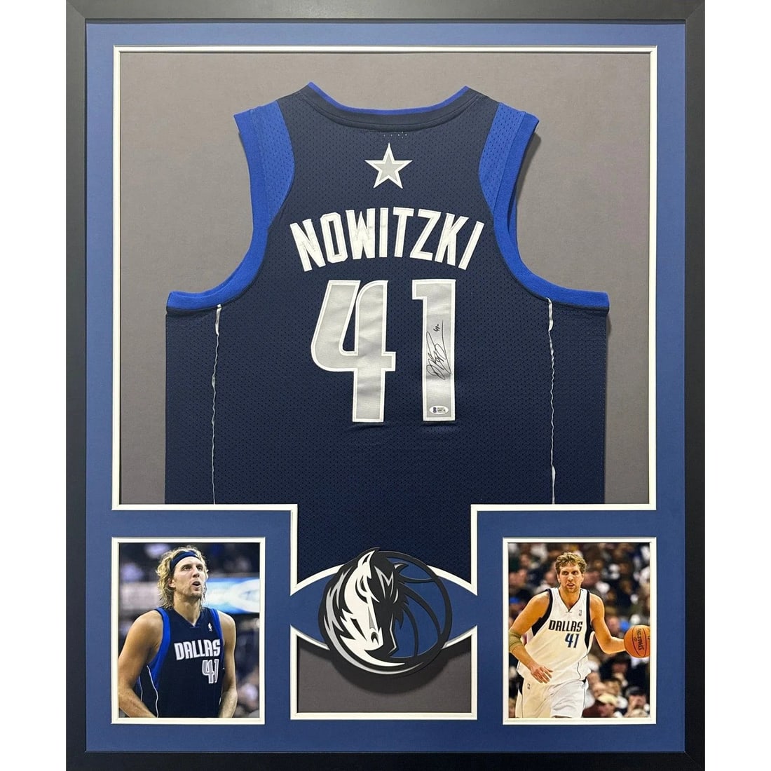 Framed Dirk Nowitzki Signed Dallas Mavericks Jersey with Beckett Authentication: Framed Dirk Nowitzki Signed Dallas Mavericks Jersey with Beckett Authentication This is a pre-owned Dallas Mavericks navy jersey autographed by Dirk Nowitzki, professionally framed and authenticated b
