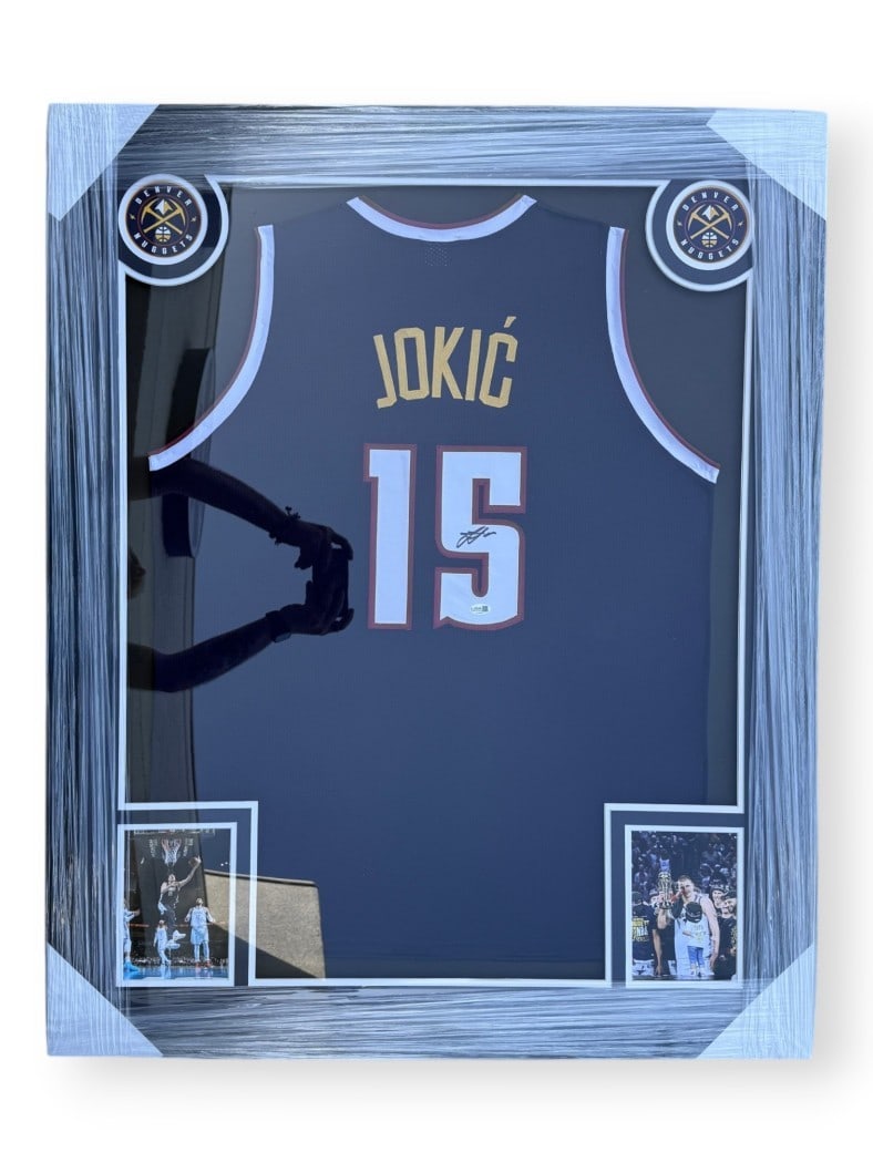 Framed Blue Jersey Signed by Nikola Jokic JSA Authenticated Denver Nuggets: Framed Blue Jersey Signed by Nikola Jokic JSA Authenticated Denver Nuggets This framed blue Denver Nuggets jersey is autographed by NBA player Nikola Jokic. The jersey comes with a James Spence Authen