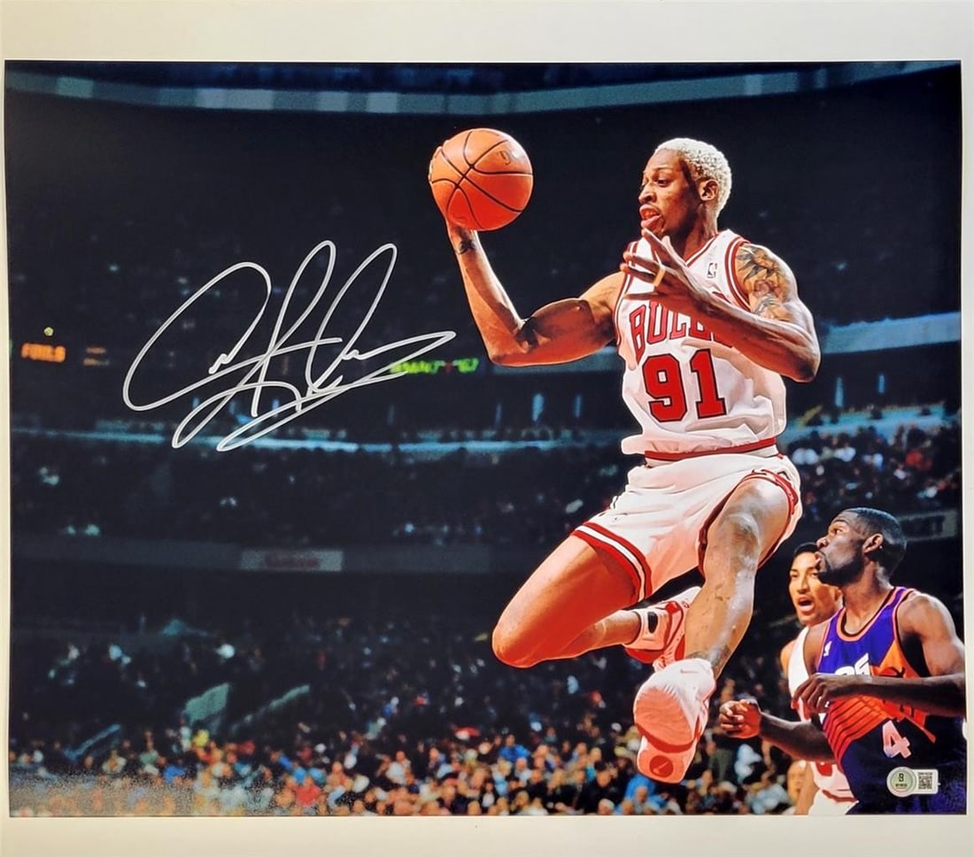 Dennis Rodman Signed 16x20 Bulls Photo Beckett Authenticated: Dennis Rodman Signed 16x20 Bulls Photo Beckett Authenticated This stunning 16x20 photograph captures Dennis Rodman in action while playing for the Chicago Bulls during a game against the Suns. The pho