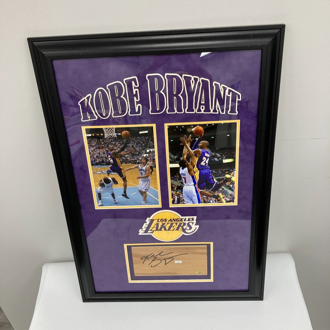 Framed Kobe Bryant Lakers floor piece with Panini COA JSA 9 MINT: Framed Kobe Bryant Lakers floor piece with Panini COA JSA 9 MINT This professionally custom-framed display features an original Los Angeles Lakers floor piece signed by Kobe Bryant. The item includes 