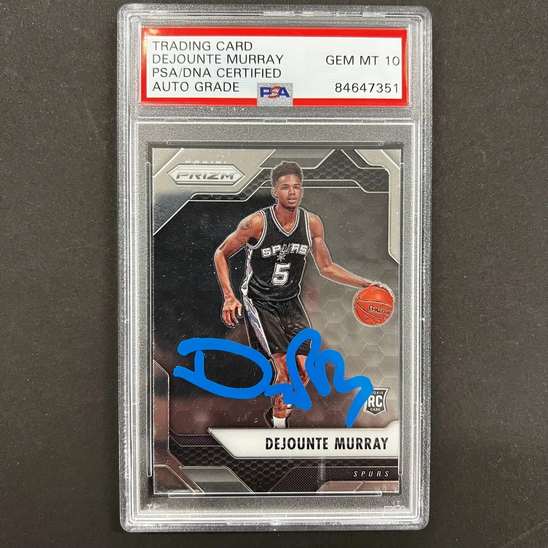 PSA Slabbed Dejounte Murray Auto Panini Prizm #236 Spurs Card: PSA Slabbed Dejounte Murray Auto Panini Prizm #236 Spurs Card This is a 2017-18 Panini Prizm #236 basketball trading card featuring Dejounte Murray of the San Antonio Spurs. The card is hand-signed by