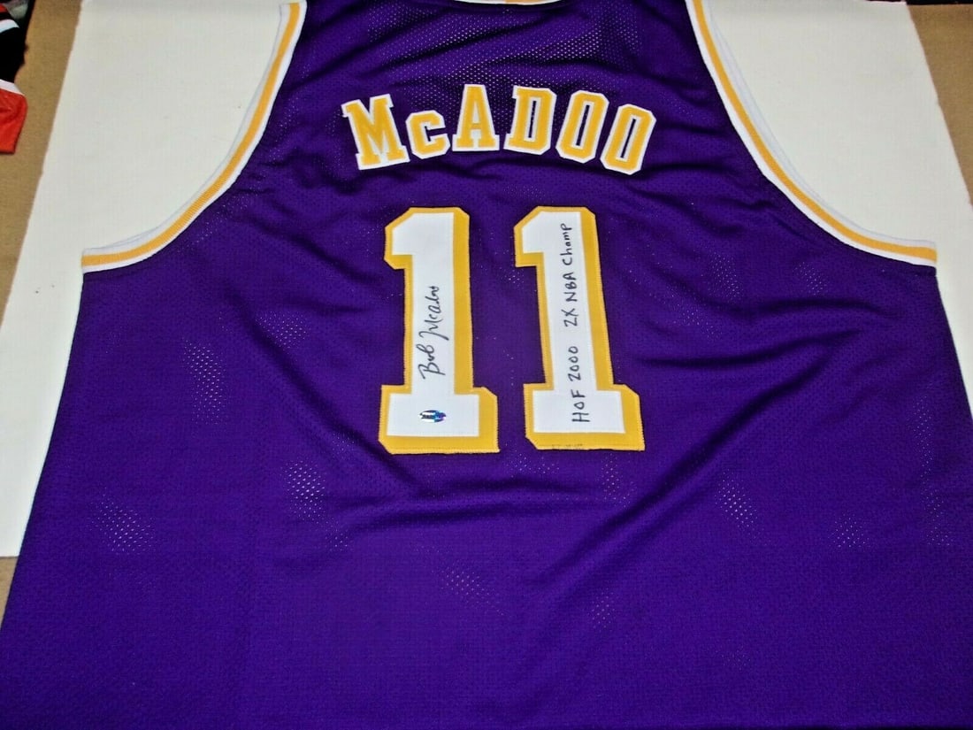 Bob McAdoo Signed LA Lakers Jersey Purple with COA HOF 2000: Bob McAdoo Signed LA Lakers Jersey Purple with COA HOF 2000 Showcase your support for basketball legend Bob McAdoo with this authentic Los Angeles Lakers jersey. Celebrated as a Hall of Famer since 20