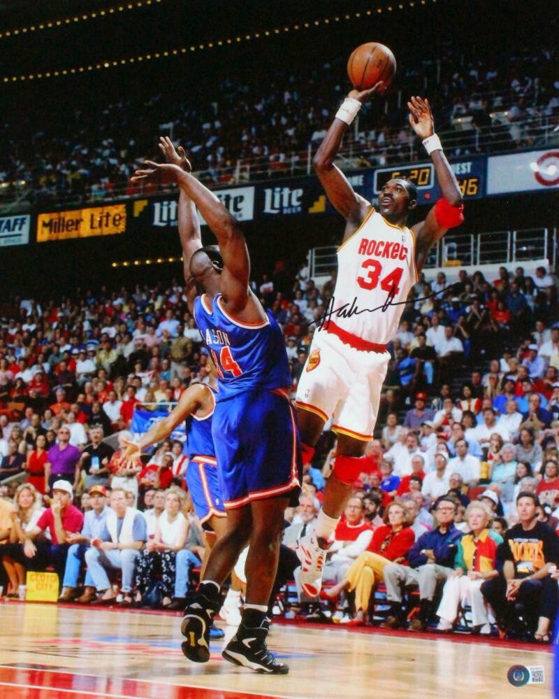 Hakeem Olajuwon signed Houston Rockets 16x20 photo Fade Away Jumper: Hakeem Olajuwon signed Houston Rockets 16x20 photo Fade Away Jumper This is a 16x20 photograph featuring Hakeem Olajuwon of the Houston Rockets executing a fade away jumper against the New York Knicks