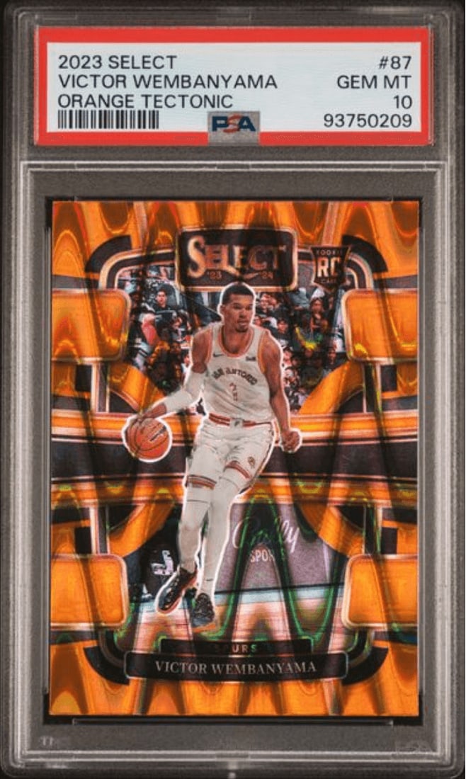 PSA 10 Victor Wembanyama 2023 Panini Select Orange Tectonic #87: PSA 10 Victor Wembanyama 2023 Panini Select Orange Tectonic #87 This is a 2023 Panini Select Victor Wembanyama #87 Orange Tectonic rookie card, professionally graded PSA 10. The card features a multic