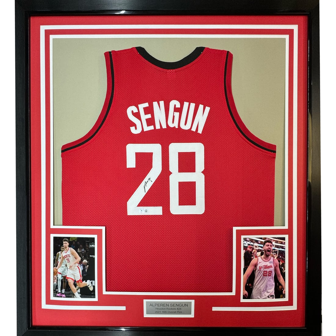 Beckett COA Framed Alperen Sengun Houston Rockets Jersey 35x39: Beckett COA Framed Alperen Sengun Houston Rockets Jersey 35x39 This professionally framed and matted display features an autographed Houston Rockets red jersey signed by NBA player Alperen Sengun. The