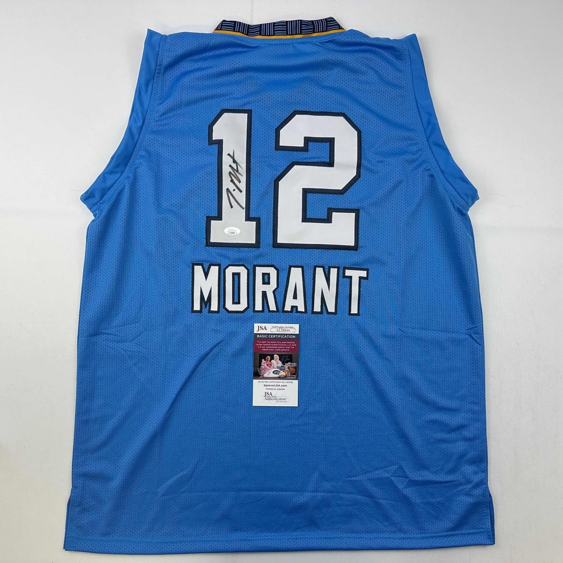 Autographed Ja Morant Memphis Light Blue Jersey with JSA COA: Autographed Ja Morant Memphis Light Blue Jersey with JSA COA This autographed Ja Morant light blue basketball jersey is a unique collectible for fans of the NBA. Featuring the name and number of the s