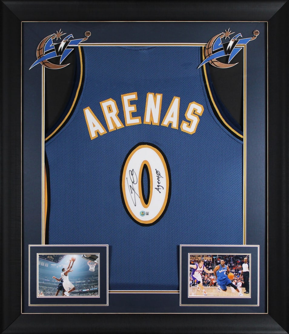 Framed Gilbert Arenas Signed Blue Jersey with Agent 0 Inscription BAS Witnessed: Framed Gilbert Arenas Signed Blue Jersey with Agent 0 Inscription BAS Witnessed This professionally framed blue pro style jersey features the personal signature and "Agent 0" inscription by Gilbert Ar