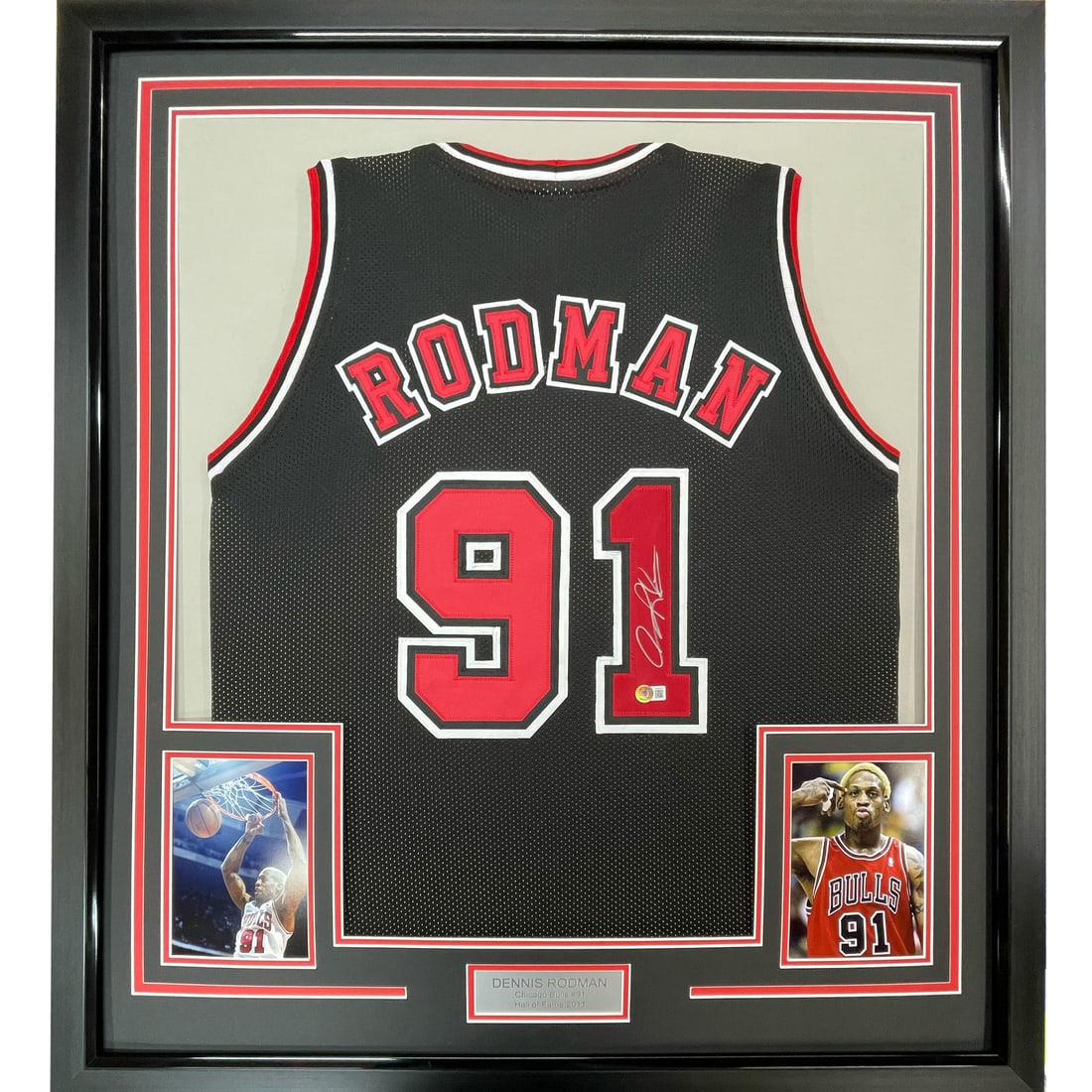 Framed Dennis Rodman signed Chicago Bulls black jersey JSA COA 33x42: Framed Dennis Rodman signed Chicago Bulls black jersey JSA COA 33x42 This professionally framed and matted display features a Chicago Bulls black jersey autographed by Dennis Rodman. The jersey is aut