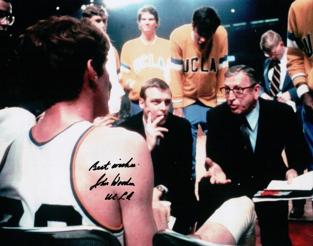 8x10 Photograph Signed by John Wooden with UCLA Inscription Authenticated: 8x10 Photograph Signed by John Wooden with UCLA Inscription Authenticated This is an original 8x10 photograph autographed by John Wooden, featuring the inscription "Best Wishes UCLA". The photo origin
