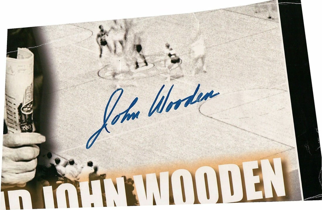 John Wooden Autographed Poster Cut Out 7x11 Authentic Signature: John Wooden Autographed Poster Cut Out 7x11 Authentic Signature This is an original cut-out section of a poster featuring the legendary John Wooden. The section measures approximately 7 inches high by