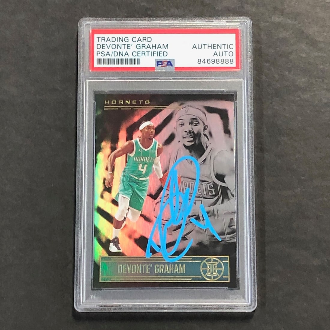 2020-21 Illusions Panini #28 Devonte' Graham Signed Card PSA/DNA: 2020-21 Illusions Panini #28 Devonte' Graham Signed Card PSA/DNA This 2020-21 Illusions Basketball Panini #28 card features the signature of Devonte' Graham, a promising player in the NBA. The autogra