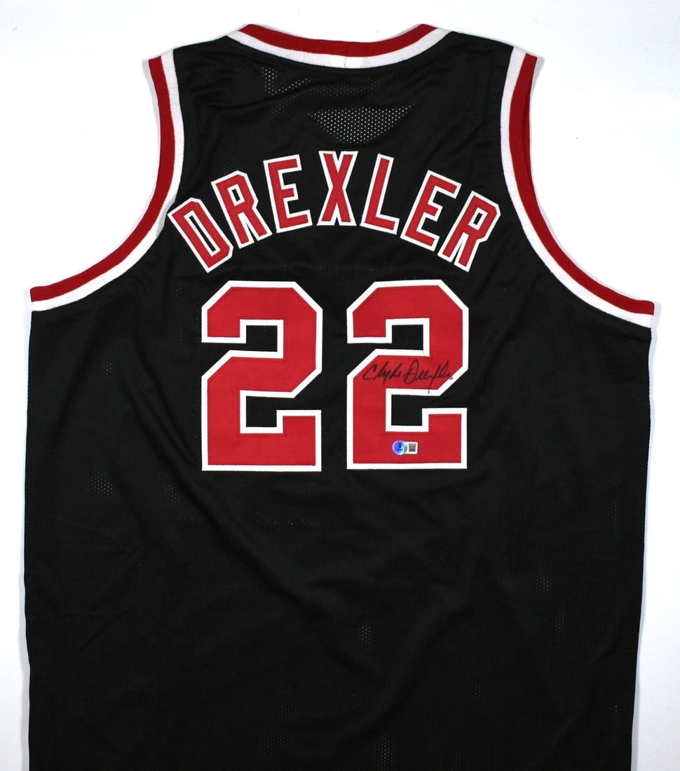 Clyde Drexler Signed Portland Trail Blazers Black Pro Style Jersey Beckett Hologram: Clyde Drexler Signed Portland Trail Blazers Black Pro Style Jersey Beckett Hologram This is a black pro style jersey autographed by Clyde Drexler. The jersey represents the Portland Trail Blazers and 