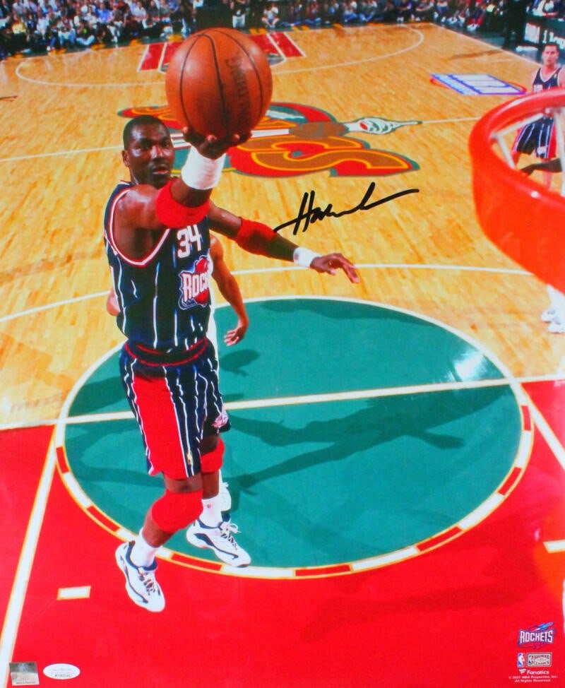 Hakeem Olajuwon signed Houston Rockets 16x20 layup photo JSA: Hakeem Olajuwon signed Houston Rockets 16x20 layup photo JSA This is an original 16x20 photograph featuring Hakeem Olajuwon of the Houston Rockets, autographed by the player. The photo captures Olajuw