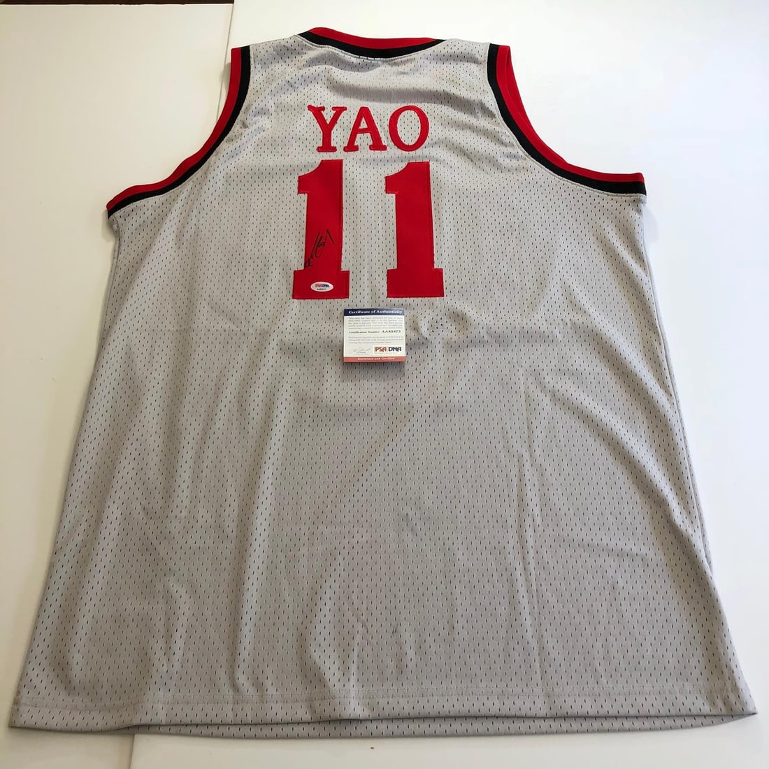 Yao Ming Autographed Houston Rockets Jersey PSA/DNA Authentic: Yao Ming Autographed Houston Rockets Jersey PSA/DNA Authentic This is an original stitched jersey autographed by basketball legend Yao Ming, a prominent player for the Houston Rockets. The authenticit